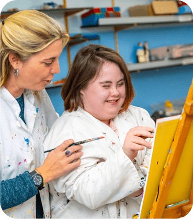 Art instructor guiding a student painting