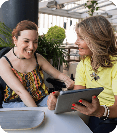 Caregiver using a tablet with a wheelchair user