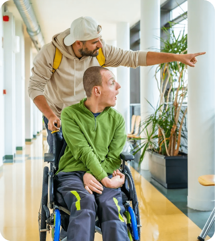 Caregiver assisting wheelchair user indoors