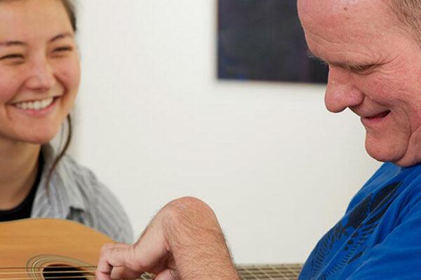 Two people enjoying a music activity together