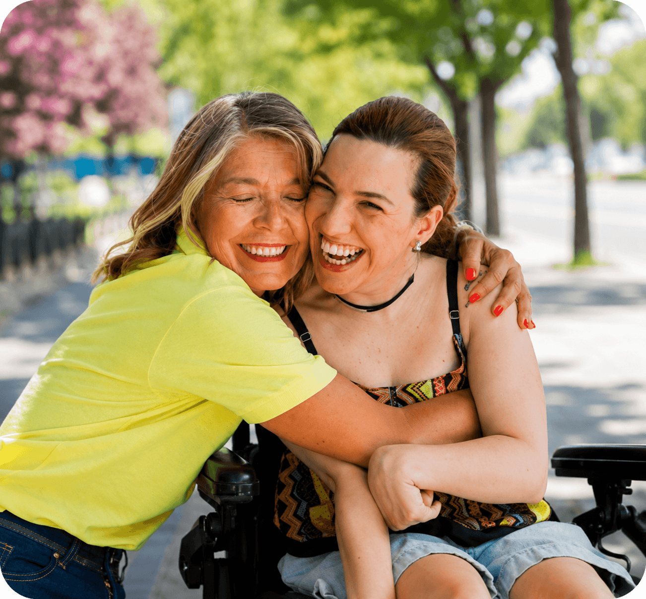 Caregiver hugging a wheelchair user